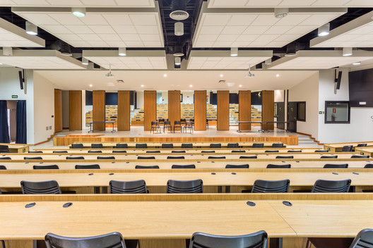 CAD3 auditorium with tiered seating, desks, and a stage